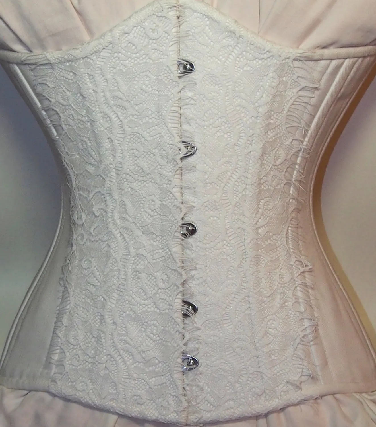 Exclusive white bridal steel-boned corset for tight lacing covered by laces. Lace Addicted Corsettery collection. Wedding, bridal corset